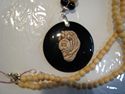 ID-#3. Shar-Pei head. Onyx stone background with beaded necklace.